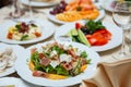 Fresh mix salad with ham, feta and mango on white plate. restaurant table setting Royalty Free Stock Photo