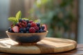 Fresh mixed berries in a bowl on a wooden table Royalty Free Stock Photo