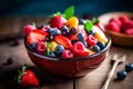 fresh mixed berries and fruit salad in bowl on top of wooden table Royalty Free Stock Photo