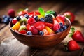 fresh mixed berries and fruit salad in bowl on top of wooden table Royalty Free Stock Photo