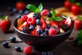 fresh mixed berries and fruit salad in bowl on top of wooden table Royalty Free Stock Photo