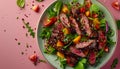 Fresh Mixed Greens Salad with Sliced Steak, Vegetables, and Fruit Garnish on Modern Tableware Royalty Free Stock Photo