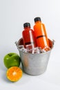 Fresh mixed juice bottle freeze by ice in bucket to keep cool nutrient and vitamin refreshment of fruit extract from ripe orange Royalty Free Stock Photo
