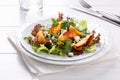 Fresh mixed salad on white. Lettuce and arugula leaves with grilled peach and blue cheese