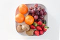 Fresh mixed sweet fruit on plate over white Royalty Free Stock Photo