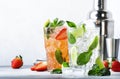 Fresh Mojito cocktail set with lime, mint, strawberry and ice in glass on gray background. Summer cold alcoholic non-alcoholic Royalty Free Stock Photo