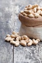Fresh monkeynut in sack bag on wooden background Royalty Free Stock Photo