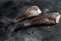 Fresh monkfish without a head. Black background. Top view