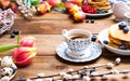 Fresh morning coffee and pastries homemade for breakfast. Pancakes with berries for a romantic breakfast and spring flowers. The Royalty Free Stock Photo