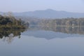 Fresh Morning with misty sky and view of Mountains and forest reflections on the lake water Royalty Free Stock Photo