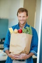 Fresh from Mother natures pantry. Portrait of a happy man holding a bag full of healthy groceries. Royalty Free Stock Photo