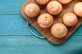 Fresh muffins on a cutting board on a wooden blue background. Ba Royalty Free Stock Photo