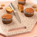 Fresh muffins on a kitchen cutting board made of artificial stone