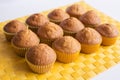 Fresh muffins on yellow napkin