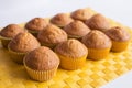 Fresh muffins on yellow napkin
