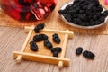 Fresh mulberry fruit on wood table background.