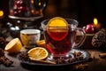 Fresh mulled wine on a wooden table on a backdrop of Christmas lights. Traditional hot Christmas drink served with spices and