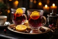 Fresh mulled wine on a wooden table on a backdrop of Christmas lights. Traditional hot Christmas drink served with spices and