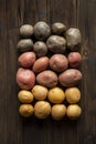 Fresh multi-colored potatoes on a wooden background