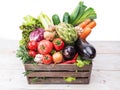 Fresh multi-colored vegetables in wooden crate. Royalty Free Stock Photo