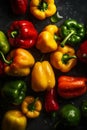 Fresh multicolored bell peppers with water droplets. On the table in close-up.