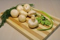 Fresh mushrooms with herbs on a wooden board.