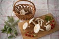 Fresh mushrooms with tomatoes and knife on wooden cutting board Royalty Free Stock Photo