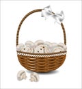 Fresh mushrooms in a wicker basket with a bow.