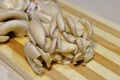 Fresh mushrooms on a wooden board on the table.