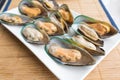 Fresh mussels in white dish on the table Royalty Free Stock Photo