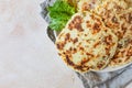 Fresh naan bread with avocado and sprouts, concrete background. Traditional homemade wheat flour flatbread on plate. Top view