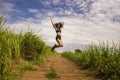 Natural lifestyle portrait of young attractive and happy hipster woman with curly hair feeling free jumping on the air enjoying Royalty Free Stock Photo