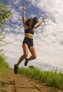 Natural lifestyle portrait of young attractive and happy hipster woman with curly hair feeling free jumping on the air enjoying Royalty Free Stock Photo