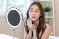 Fresh, nice healthy skin, beautiful of asian young woman, girl looking at mirror, touching her face with before make up cosmetic Royalty Free Stock Photo