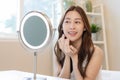 Fresh, nice healthy skin, beautiful of asian young woman, girl looking at mirror, touching her face with before make up cosmetic Royalty Free Stock Photo