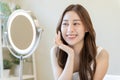 Fresh, nice healthy skin, beautiful of asian young woman, girl looking at mirror, touching her face with before make up cosmetic Royalty Free Stock Photo