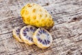 Fresh noni fruit and noni slice on wooden background and space.slice of noni fruit with space on wooden background Royalty Free Stock Photo