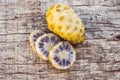 Fresh noni fruit and noni slice on wooden background and space.slice of noni fruit with space on wooden background Royalty Free Stock Photo