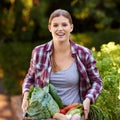 Fresh or nothing. Portrait of a happy young woman holding a crate full of freshly picked vegetables. Royalty Free Stock Photo