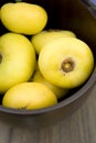 Fresh nutmeg in wooden bowl