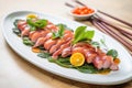 fresh octopus sashimi arranged artistically on ceramic dish