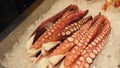 Fresh octopus tentacles skewered on a bed of crushed ice Royalty Free Stock Photo