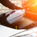 Fresh oil being poured during an oil change to car engine in ray Royalty Free Stock Photo