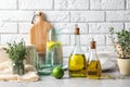 Fresh olive oil and kitchen utensils on table Royalty Free Stock Photo