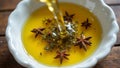 Fresh olive oil pouring into dish with floating herbsspices Royalty Free Stock Photo