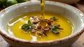 Fresh olive oil pouring into dish with floating herbsspices Royalty Free Stock Photo