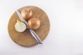 Fresh onion bulbs with knife on cutting board , isolated on whit Royalty Free Stock Photo