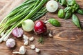 Fresh onions, basil and garlic on wooden background