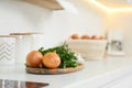 Fresh onions and parsley on white countertop in modern kitchen Royalty Free Stock Photo