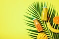 Fresh orange, banana, pineapple, mango smoothie and juicy fruits on palm leaves over yellow background. Detox summer Royalty Free Stock Photo